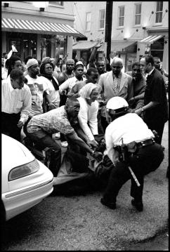 Protesters attempt to defend a fellow marcher from police during the protests in Cincinnati in 2001 (Ryan Thomas)