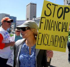 A woman in Gucci sunglasses protests her "enslavement" by taxation (Steve Rhodes)
