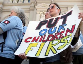 A teacher from San Francisco joins in protests against budget cuts in Sacramento in March