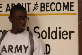 A new recruit to the Army waits in line during the intake process (Staff Sgt. Manuel J. Martinez)