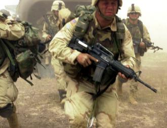 U.S. soldiers rush off a Chinook helicopter in Afghanistan (Spc. Marshall Emerson)