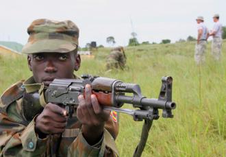 Ugandan troops on training exercises as U.S. "advisers" look on in the background (Master Sgt. Ruby Zarzyczny)