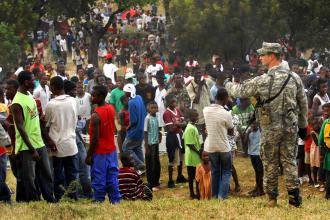 A U.S. soldier monitors a crowd of people waiting for aid in Haiti (Fred W. Baker III)