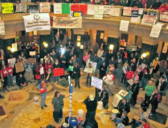 A crowd gathers in the Wisconsin Capitol rotunda to hear speakers talk on the people's mic (Angela Payne)