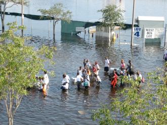 People attempting to flee New Orleans on foot after Hurricane Katrina struck
