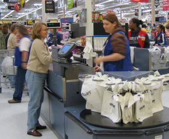 A Wal-Mart worker at the checkout line