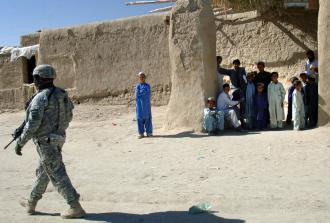 A U.S. soldier moves through Pana, Afghanistan, during a cordon and search (Staff Sgt. Michael L. Casteel)