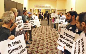 Protesters line the hallway outside the Stars and Stripes event  (Sarah Farahat)