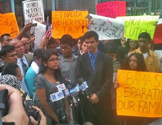 Nadia Habib (at the microphones) speaks at a press conference and rally, with supporters surrounding her (Danny Lucia | SW)