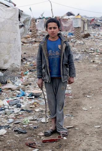 An internally displaced refugee living in a camp outside Baghdad that was built on a garbage dump