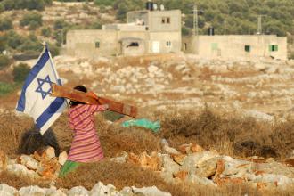 An Israeli girl walks past an illegal outpost of the Jewish settlement of Avnei Hefetz in the West Bank (Gili Yaari)