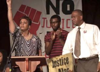 Jeralynn and Adam Blueford (at left and right) onstage at a Bay Area meeting against police violence (WeAreMany.org)