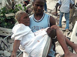 A man carries an injured woman from the rubble after the earthquake in Port-au-Prince (Clarens Renois | AFP)