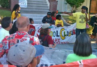 A Lakeview parent who was part of the occupation speaks to marchers in Oakland (Jessie Muldoon | SW)