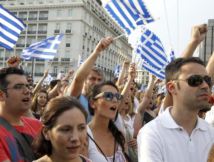 Protesters outside the Greek parliament chant and rally against austerity