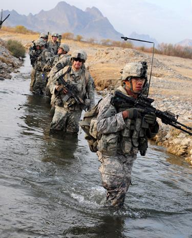 U.S. soldiers cross a stream during a security patrol in Chabar, Afghanistan