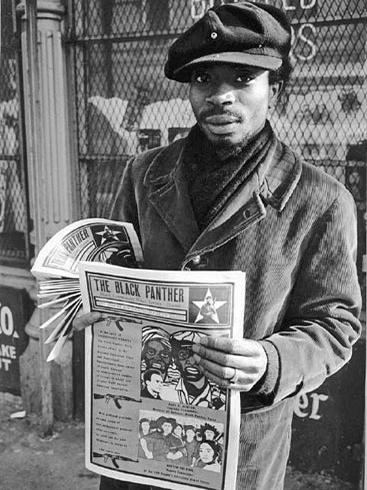 A member of the Black Panther Party sells copies of its widely read newspaper