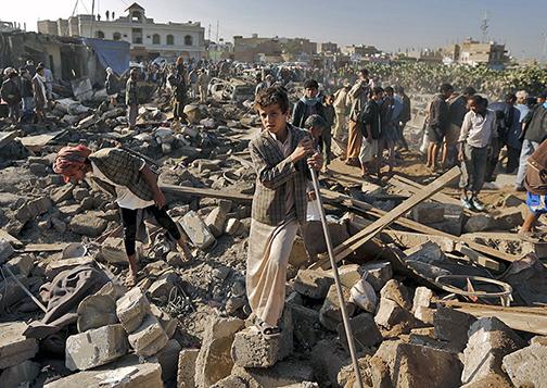 Searching through the rubble left behind after a Saudi air strike in Yemen