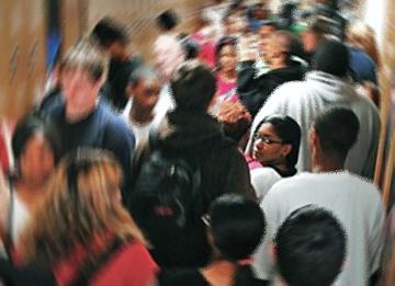 High school students crowd into a hallway between classes