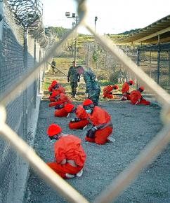 Detainees sit in a holding area at Camp X-Ray at the U.S. Naval Base in Guantánamo Bay, Cuba, on January 11, 2002.