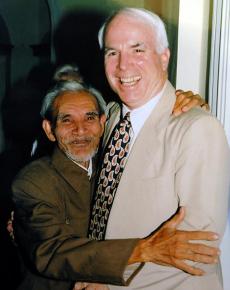 John McCain hugs his rescuer Mai Van On at a meeting in 1996