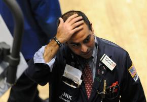 A Wall Street trader watches as the stock market crashes in reaction to the bankruptcy of Lehman Brothers