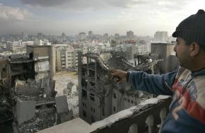 A man looks out over the wreckage left by Israeli air strikes in Gaza City