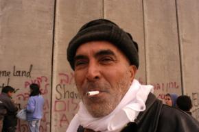 A still from the film "Citizen Nawi" shows Ezra in front of Israel's apartheid wall