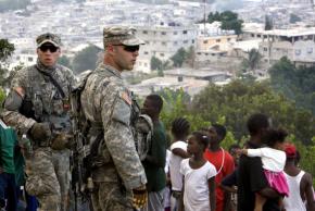 U.S. Marines stand guard at a food distribution point in Port-au-Prince