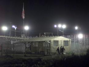 A prisoner is moved from one building to another at the prison camp at Guantánamo Bay