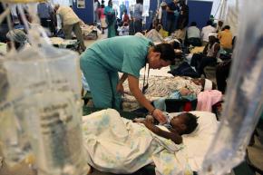 Emergency staff care for injured Haitians in a field hospital in Port-au-Prince