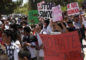Protesters march against SB 1070 outside the Arizona Capitol Building in Phoenix