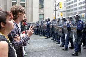 Protesters face police clad in riot gear in Toronto during the G20 summit
