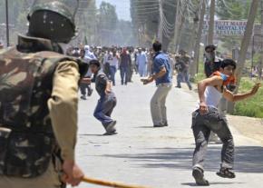 Indian security forces rush a crowd during efforts to contain protests in Kashmir