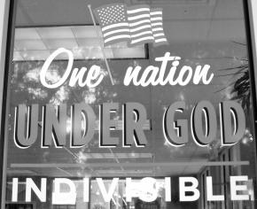 A storefront window painted with the American flag