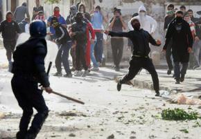 Protesters confront police during a street battle in Algiers
