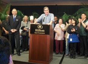 HERE Local 2 President Mike Casey announces an agreement with the San Francisco Hilton as hotel General Manager Michael Dunne looks on
