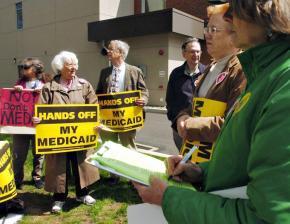 Protesters stand outside their congressman's office to say no to cuts in medicaid