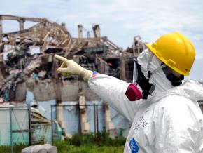 Inspectors survey the damage at one of the Fukushima-Daiichi nuclear plant's reactors
