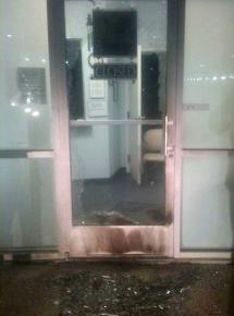 The shattered front door of a North Texas clinic following an arson attack