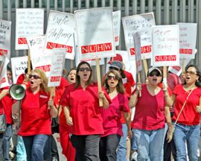 Health care workers march outside the Kaiser Permanente Los Angeles Medical Center