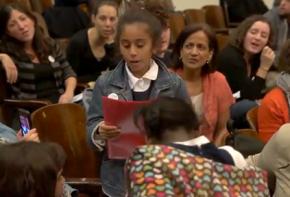 A third grade student uses the people's microphone inside the PEP meeting in New York City