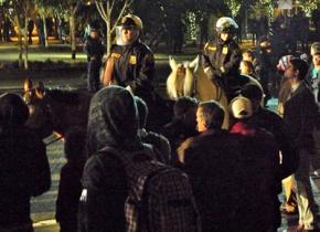 Police on horseback look on as other law enforcement in arrest Portland occupiers