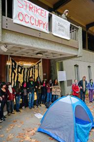 Protesters defend the entrance to the occupied Hahn Student Services building at UCSC