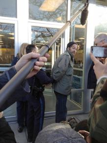 An Occupy protester is arrested outside Mitt Romney's campaign headquarters in Des Moines