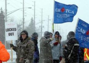 Locked-out Caterpillar workers picket in the snow in London, Ontario, Canada