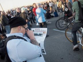 Checking out an issue of the Occupied Oakland Tribune during the November 2 day of action