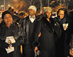 Danelene Powell-Watts (second from right) marches alongside supporters in a vigil for her son Stephon