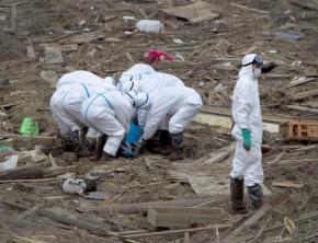 Worker sort through wreckage surrounding the Fukushima-Daiichi nuclear plant