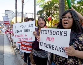 Teachers from the UTLA join community members to protest cuts to public schools
